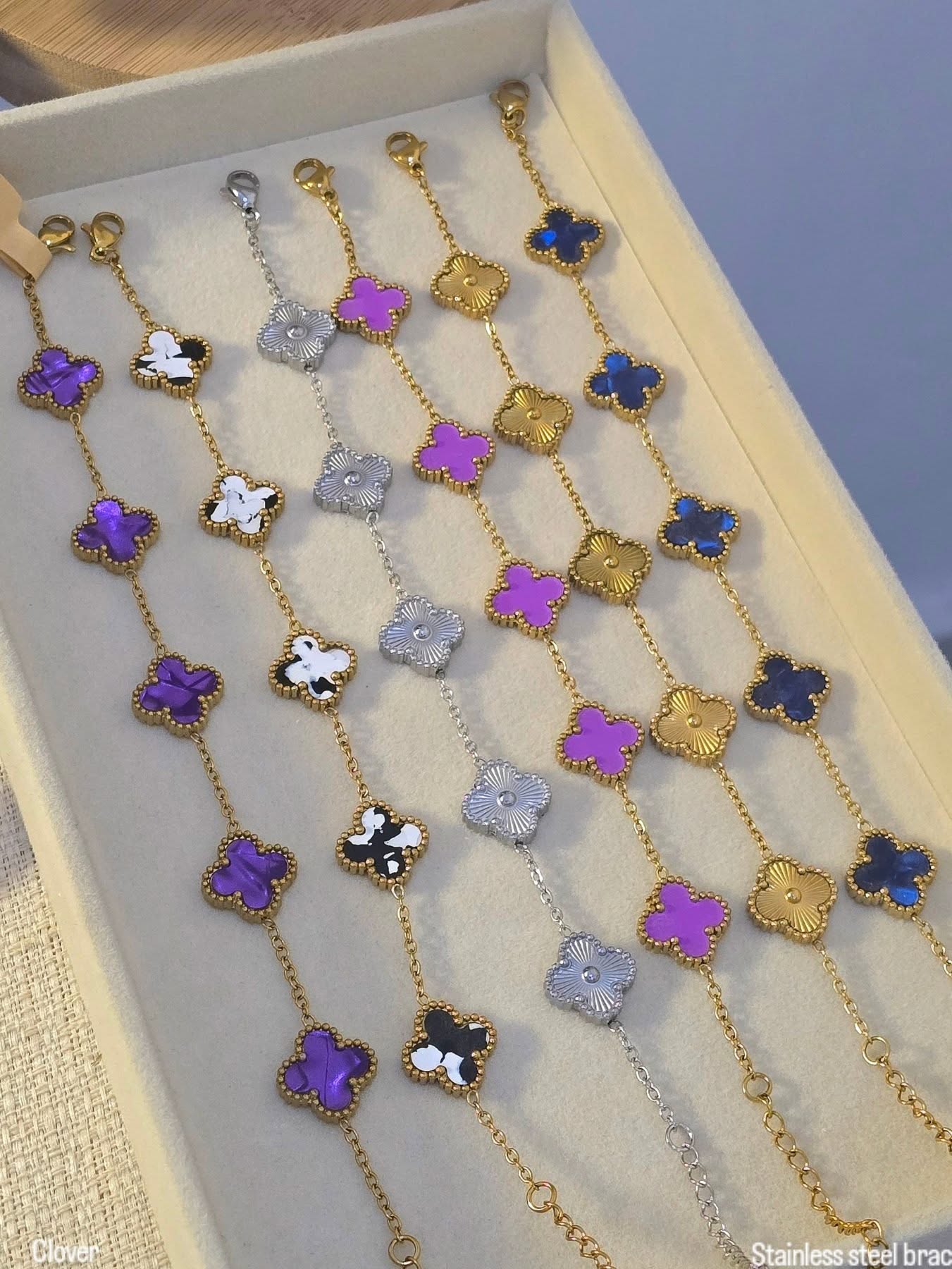 clover chain bracelets.The bracelets feature gold-plated chains with 5 clover charms ...black and white and silver in stock.